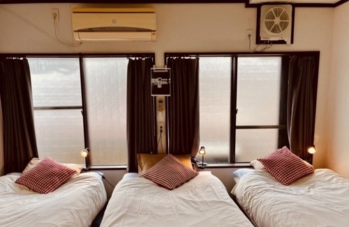 Higashinari Apartment | a room with two toilets and a shower