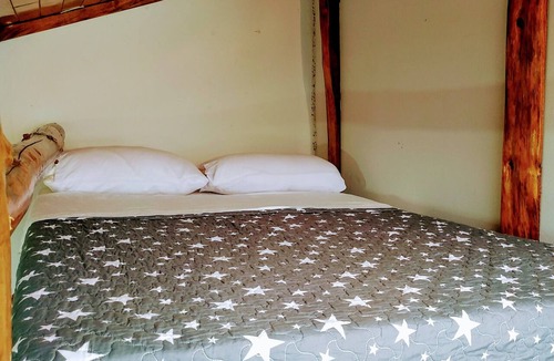 Oxapampa Cottage | Cabin-style room with wood finishes, terrace with a view of the mountains