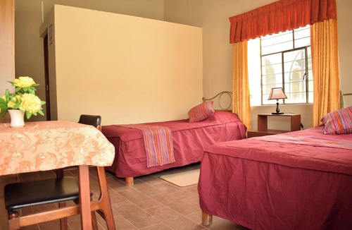 Yungar Cabin | Room with two single beds and a view of the mountains.