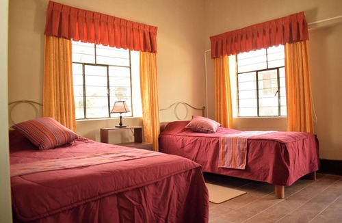 Yungar Cabin | Room with two single beds and a view of the mountains.