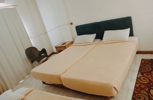 Luxor Hotel | Twin Room with King Bed Setup, Wi-Fi, AC & Private Bathroom