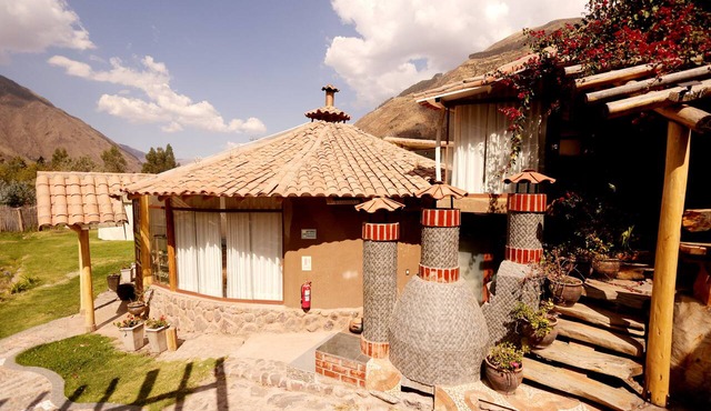 An intimate retreat in the Sacred Valley, with a sauna, hot tub, and views of a waterfall and the mountains